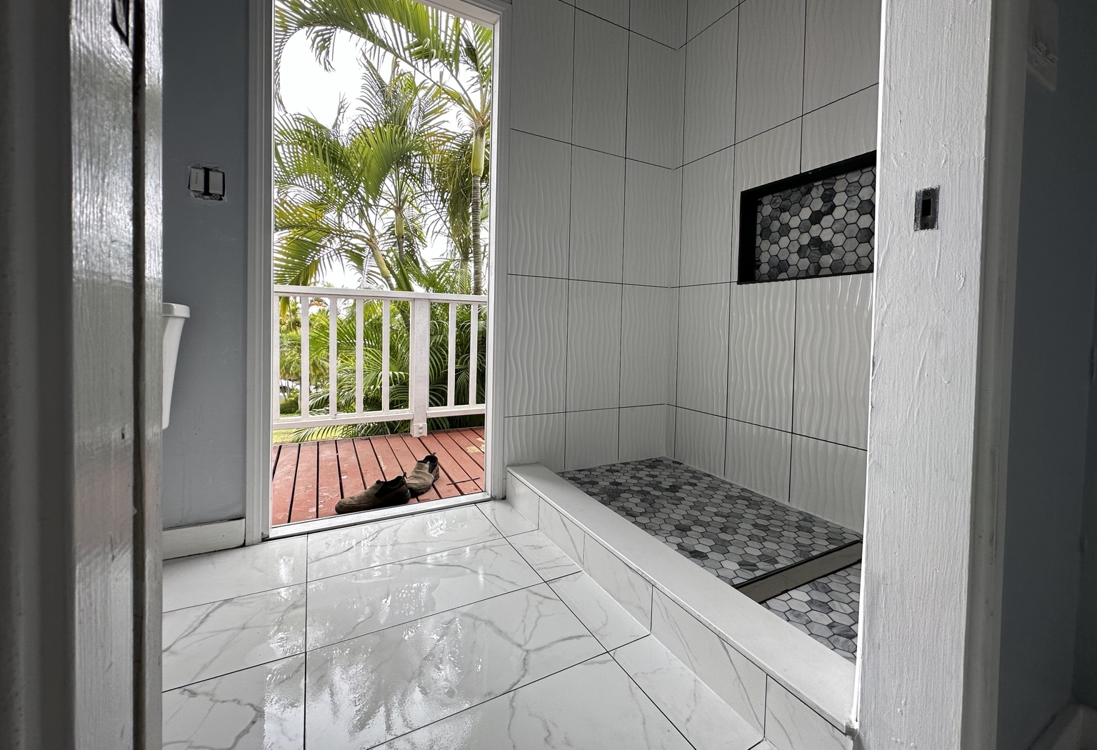 Finished bathroom remodel with palm view